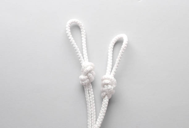 istock Rope with a knots and loops on gray background 1587029002
