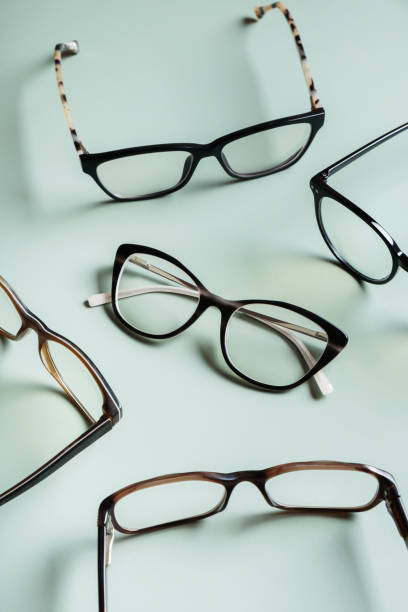 istock Stylish eyeglasses on colored background. Optical store, vision test, stylish glasses concept. 1587029541