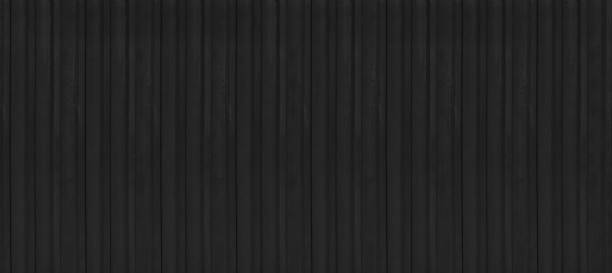 istock rusty black metal siding fence striped background 1587029547