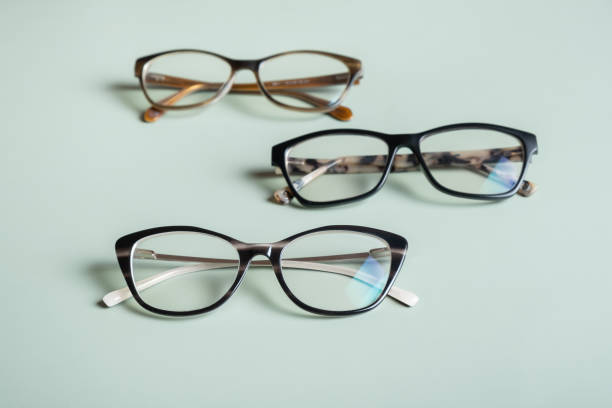 istock Stylish eyeglasses on colored background. Optical store, vision test, stylish glasses concept. 1587030107