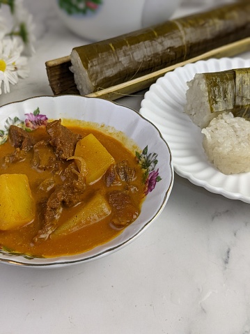 Glutinous rice is wrapped with lerek or banana leaf encased in bamboo culm and cooked in open fire / Lemang / A must have in every traditional Malay household, eaten with beef or chicken rendang
