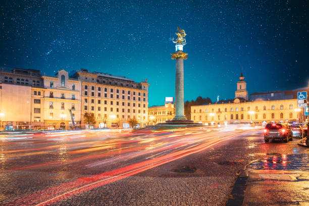 istock Tbilisi, Georgia, Eurasia. Amazing Bold Bright Blue Starry Sky Gradient Above Liberty Monument Depicting St George Slaying The Dragon And Tbilisi City Hall In Freedom Square In City Center. Travel 1587062226