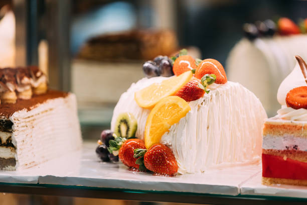 yummy assortment baked pastry in bakery. Various Different Types Of Sweet Cakes In Pastry Shop Glass Display. Good Assortment Of Confectionery. buffet with many desserts.