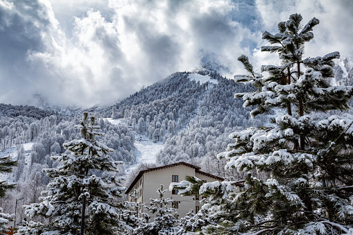 Multi-storey house in the mountains. Ski resort in winter
