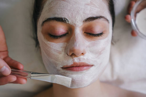 istock Woman applying cosmetic mask on face 1587119866