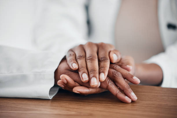 istock Doctor, patient and holding hands for help, trust and support for medical problem, depression or cancer. hand of a healthcare person and patient talking about sad results, mental health and empathy 1587126662