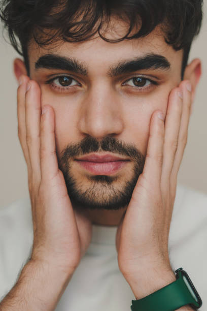 istock Young man covering face with hands 1587135488