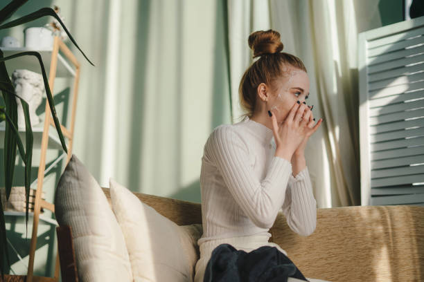 istock Young woman blowing nose 1587135956