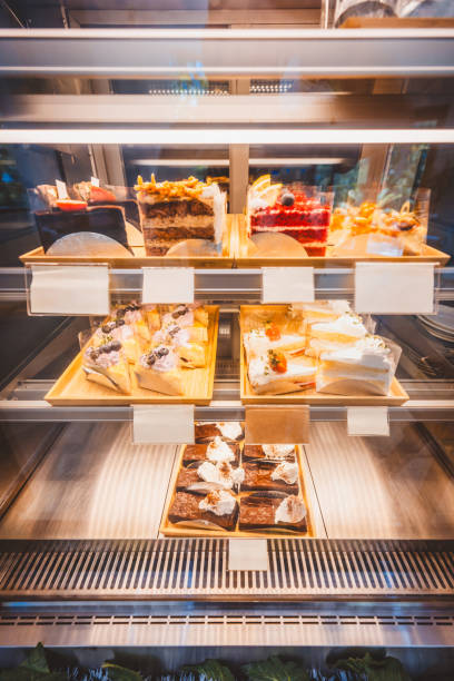 istock Slice cake in bakery glass display at shop cafe 1587137631