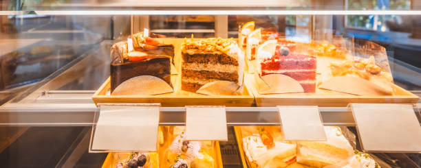 istock Slice cake in bakery glass display at shop cafe 1587137632