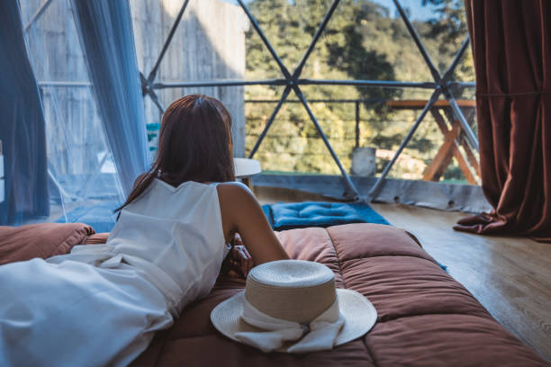 Travel woman relax inside a luxury camping dome tent