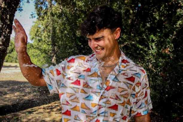 istock Young man wet at the park 1587142089