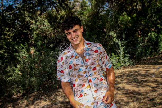 istock Young man wet at the park 1587142094