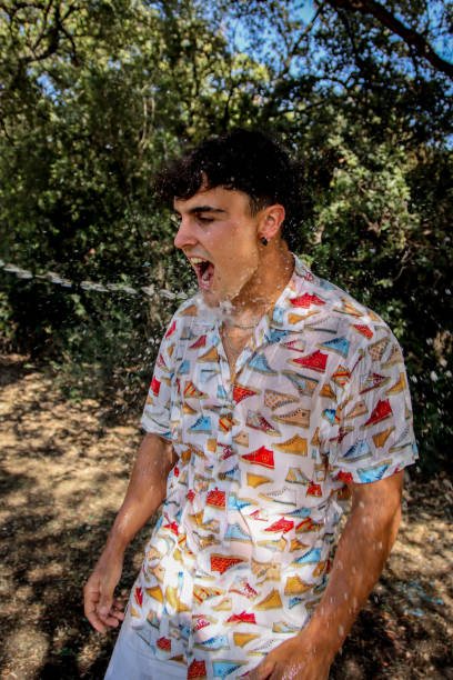 istock Young man wet at the park 1587142104