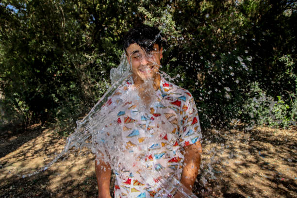 istock Young man wet at the park 1587144728