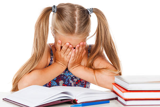 istock Tired little girl does homework 158714577