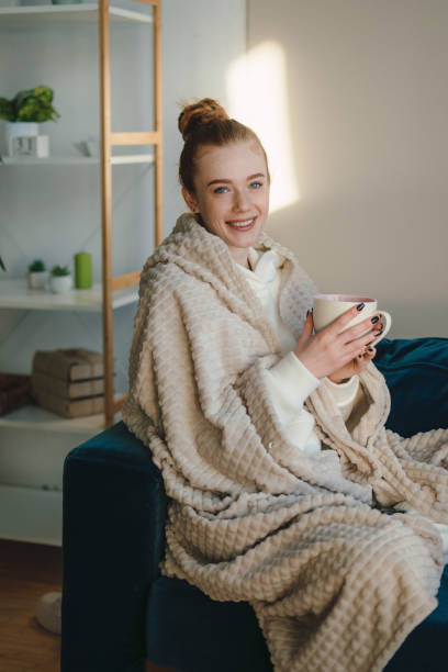 istock Smiling woman with cup of coffee 1587145784