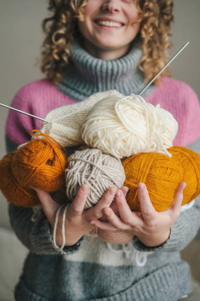 istock Smiling ethnic woman with yarn 1587145797