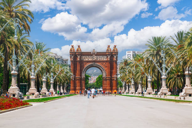 istock A red brick and stone arch Arc de Triomf at the end of a palm tree-lined boulevard in Barcelona. 1587156072