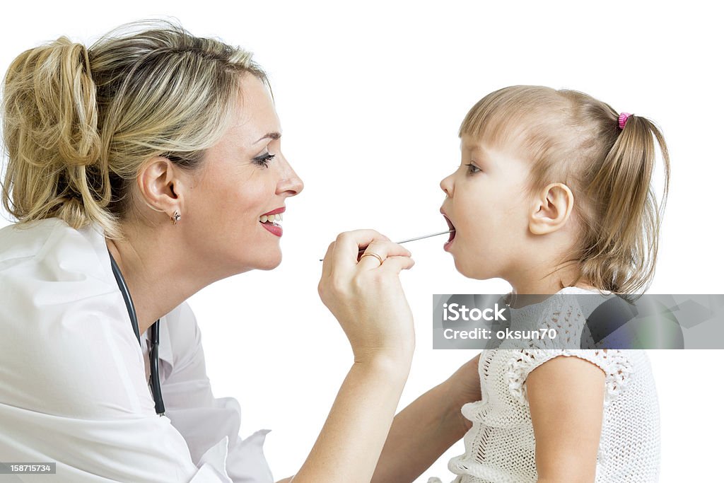 doctor examining little girl isolated on white background doctor examining kid isolated on white background Adult Stock Photo