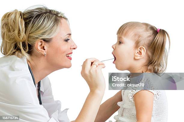 Doctor Examining Little Girl Isolated On White Background Stock Photo - Download Image Now