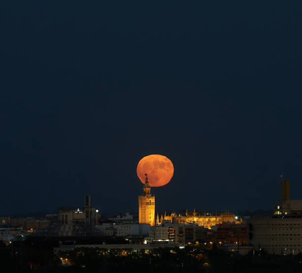 istock Night of Wonders: Supermoon Illuminates Giralda Cathedral, Seville 1587171079
