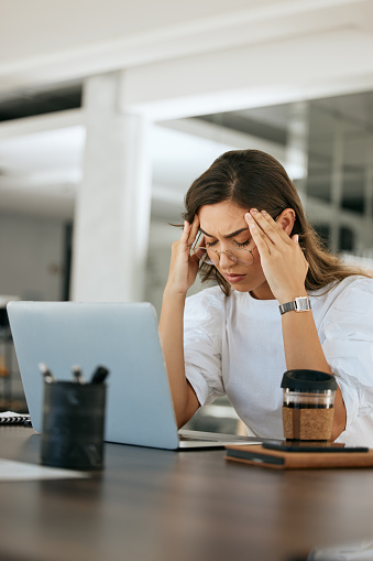 Stress, headache and laptop with business woman for burnout, overworked and anxiety. Mental health, fatigue and depression with tired employee and deadline suffering with problem, fail and mistake