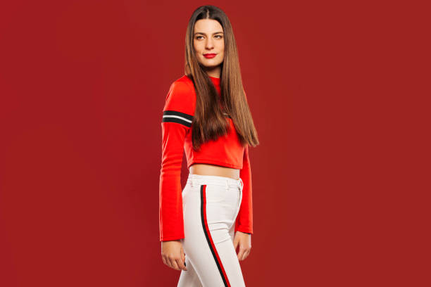 istock Positive stylish lady on red background 1587179239