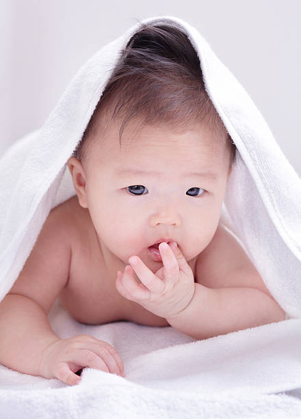 istock cute baby sucking finger 158718179
