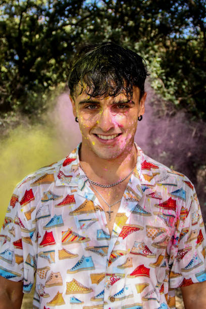 istock Young man covered in holi powder at the park 1587200667