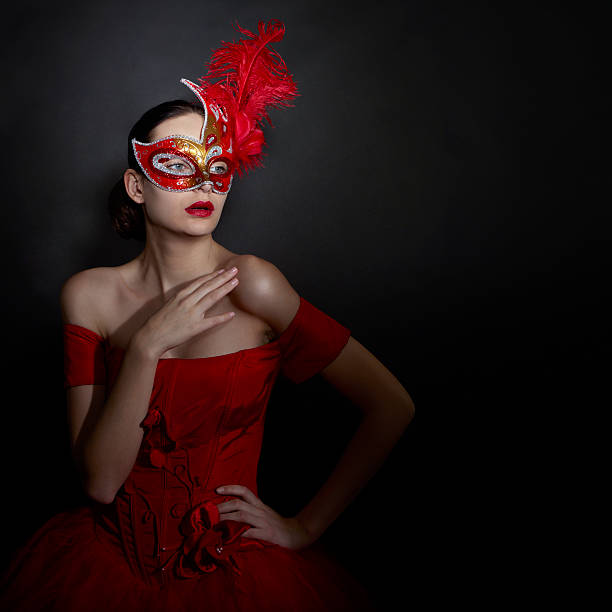 Woman in carnival mask and red evening dress. Space for text.
