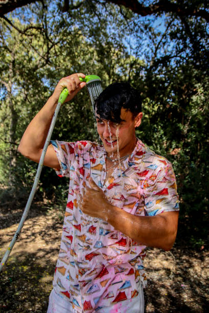 istock Young man wet at the park 1587202500