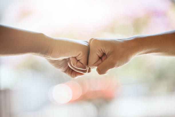 istock Teamwork, fist bump and motivation, collaboration and success for goals, trust and support. Closeup friends, greeting hands and team building, commitment and winner, solidarity and fighting racism 1587203343