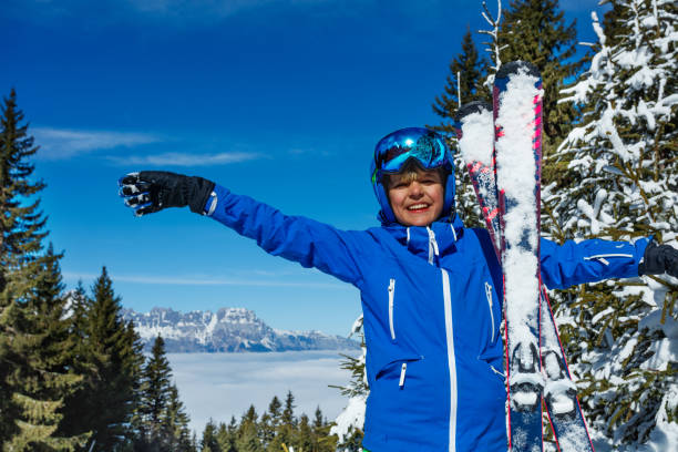 Young adult woman skiing in mountains