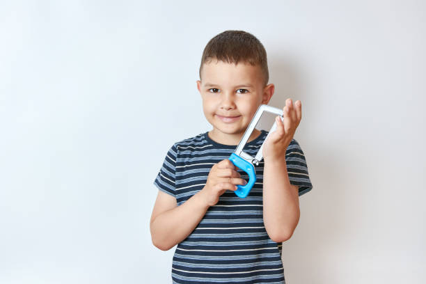 istock Little smiling boy with a toy in his hands. 1587237272