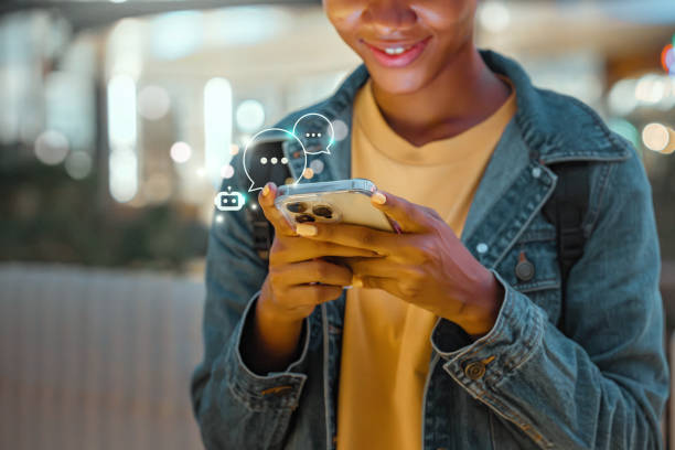 istock Digital AI chatbot, Happy young African American woman using mobile smartphone with AI chatbot for online information in night town, conversation assistant. 1587242004
