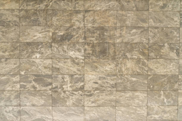 istock Granite natural stones brick wall light brown grey color detail texture 1587243606