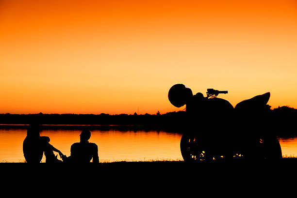 young couple at sunset stock photo