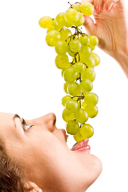 istock girl eating grapes 158725600