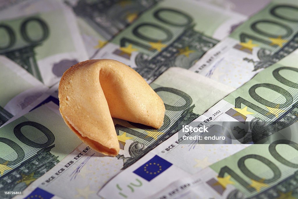 Fortune cookie Traditional Fortune Cookies on a Background of Euros. Shallow  focus. Advice Stock Photo