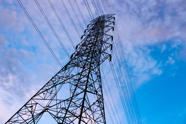 istock High voltage tower in the blue sky with concept landscape.. 1587292482
