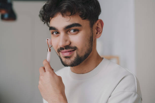 istock Positive young man smoking cigarette at home 1587294658