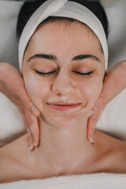 istock Woman applying cream on face 1587295178