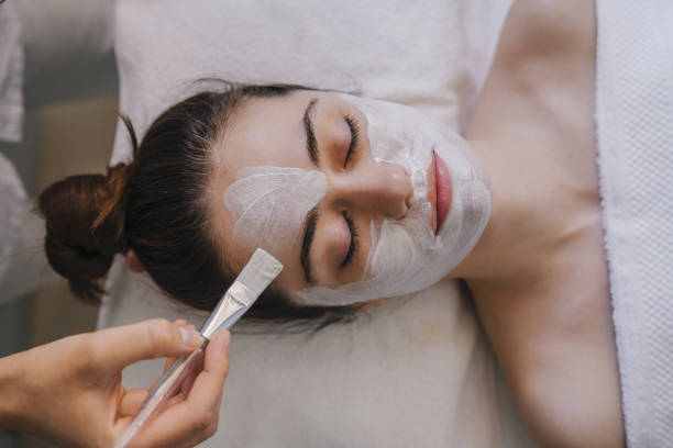 istock Woman applying cosmetic mask on face 1587295227