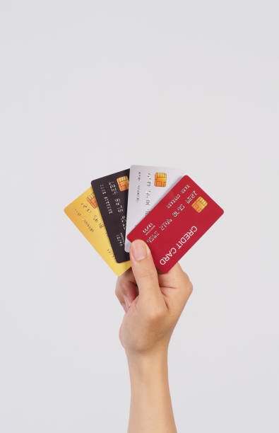 istock Hand is hold four credit cards on white background. 1587307093