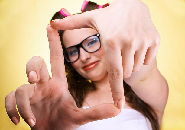 girl, making frame with hands Funny girl, making frame with hands, taking picture with imaginary camera, selective focus determination focus the bigger picture human hand stock pictures, royalty-free photos & images