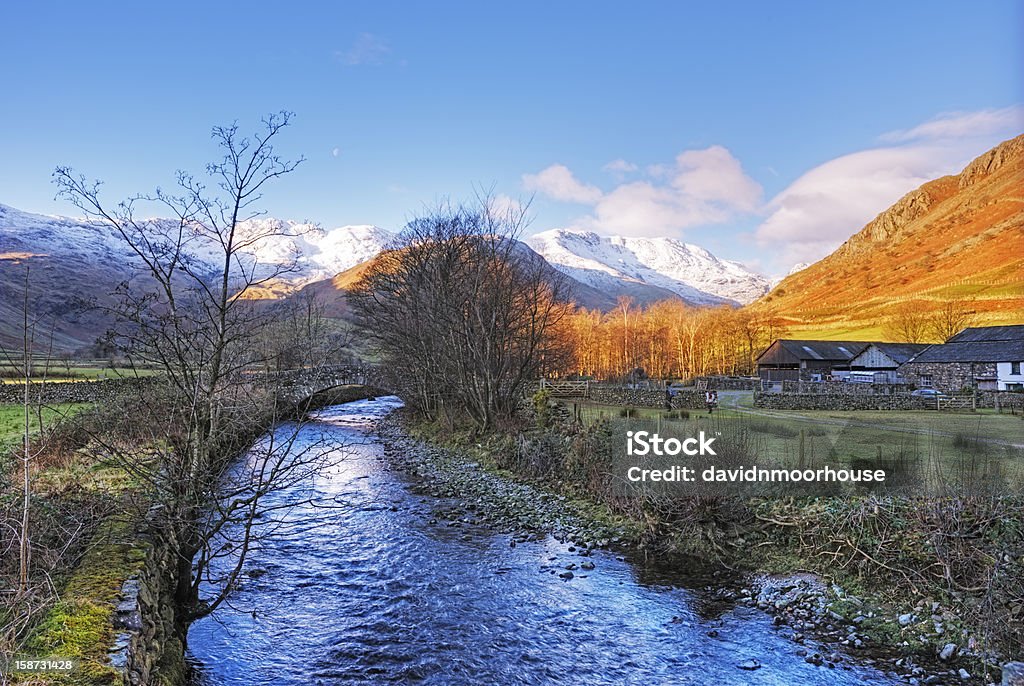 Langdale Valley English Lake District A beautiful winter day with the low sun lighting up the fellside in the upper Langdale Valley and the blue sky reflected in Great Langdale Beck. Blue Stock Photo