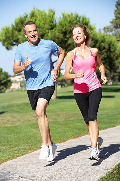 istock Senior Couple Exercising In Park 158734074