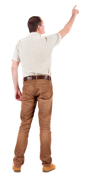vista posterior de señalando el joven hombre en camisa y pantalones - looking at view watching pointing showing fotografías e imágenes de stock