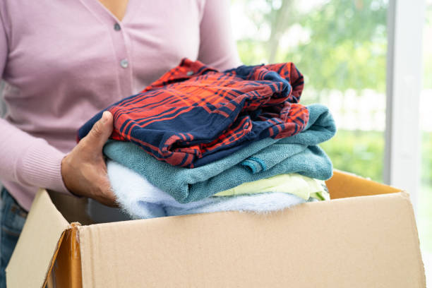 istock Donation box with used clothes at home to support help for poor people in the world. 1587355648
